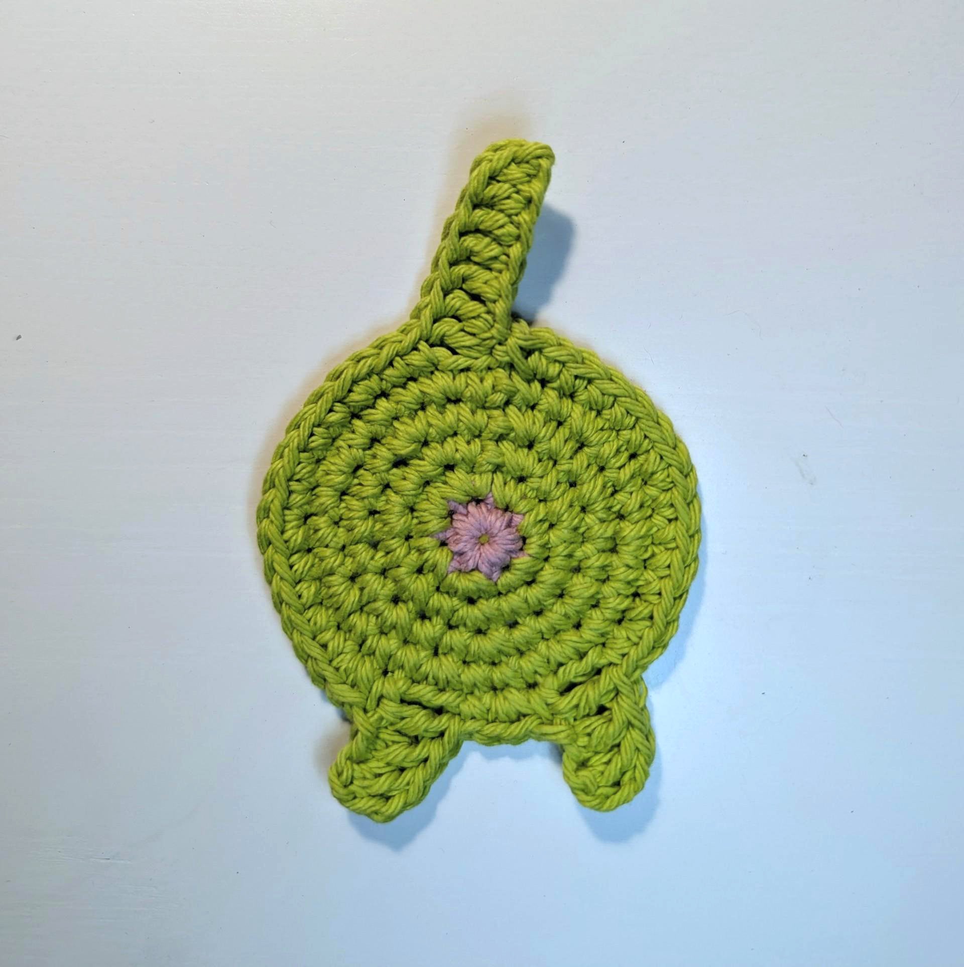 A green cat butt coaster