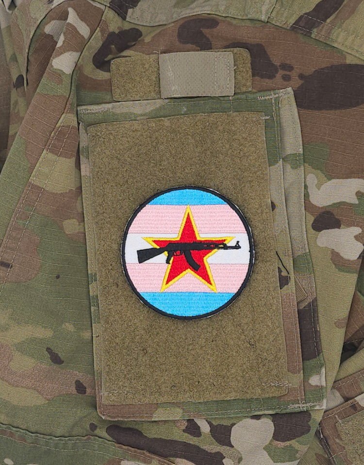 Three inch velcro patch. The Trans flag with a red star and an AK-47