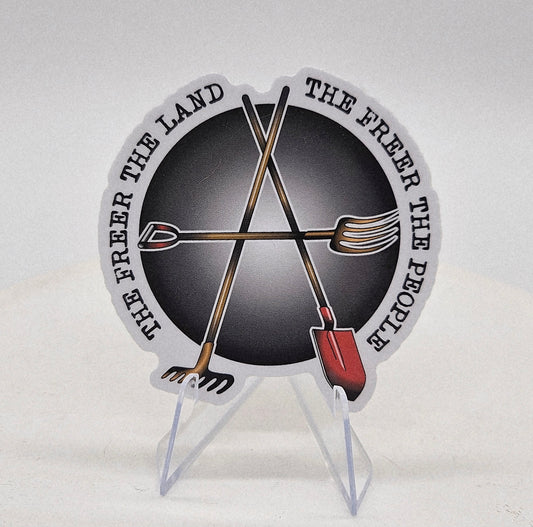 Sticker with garden impliments making an Anarchy A symbol. Text reads The Freer the land the freer the people