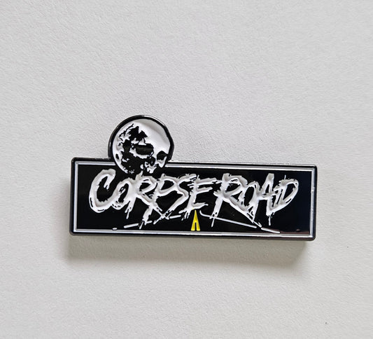 Pin with 'CORPSE ROAD' text on a white background