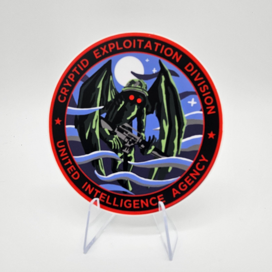 Circular logo with a Mothman and text on a stand against a white background