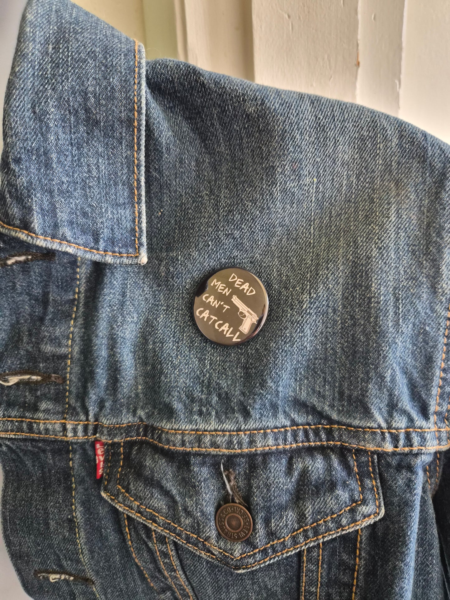 Dead men can't cat call Button
